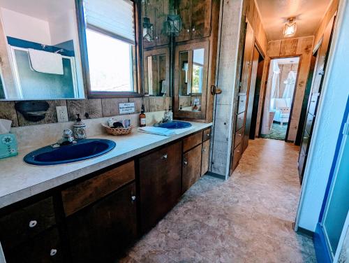 a bathroom with two sinks and a mirror at 4 Elements House:Central, Views-Every Rm, AC, Pets in Mount Shasta