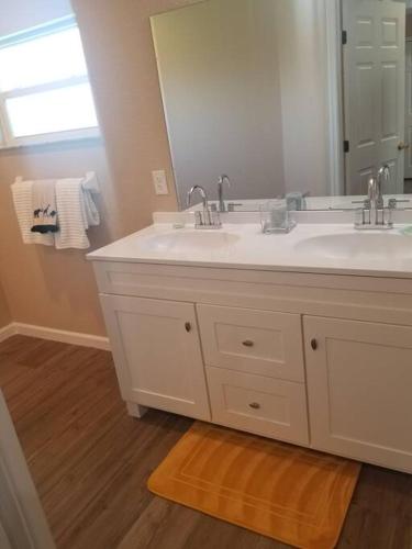 a bathroom with two sinks and a large mirror at Home Sweet Home in Fort Myers