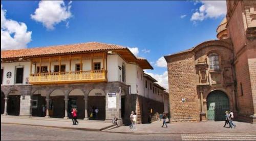 a group of people walking in front of a building at Katari at Plaza de Armas Cusco in Cusco