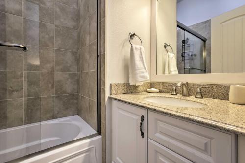 a bathroom with a sink and a tub and a mirror at Bright and Spacious EagleVail Escape Near BC and Vail! in Avon