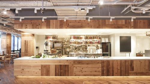 a kitchen with wooden cabinets and a counter top at Hotel Metropolitan Kamakura in Kamakura