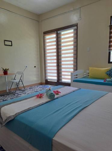 a bedroom with a large bed with flowers on it at Happy's Homestay in Boracay