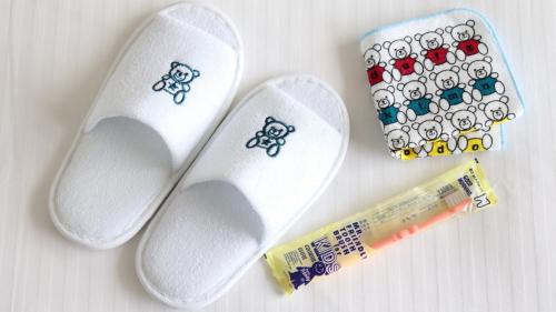 a pair of white socks with stickers on them and a toothbrush at Hotel Metropolitan Kamakura in Kamakura