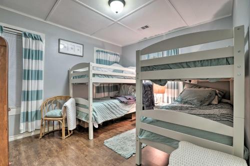 a room with two bunk beds and a chair at Historic Galveston Home Walkable Neighborhood! in Galveston