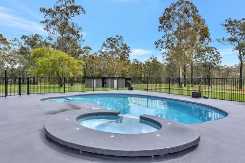 a swimming pool in a park with a fence at Kitchener Country Estate with Pool Hot Tub on private acres that sleeps up to 18 in Kitchener