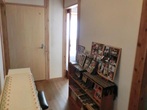 a living room with a bench and some pictures at 交流の宿 in Musashino