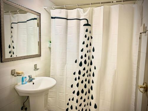 a bathroom with a white shower curtain and a sink at SOYA`S HOUSE in Busan