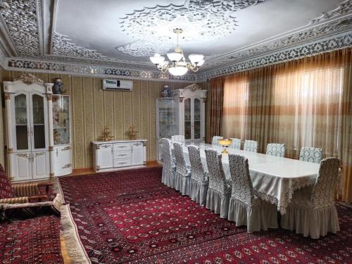 a large room with a table and chairs in it at Sulton-Sayyor in Khiva