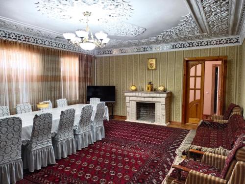 a room with a table and chairs and a fireplace at Sulton-Sayyor in Khiva