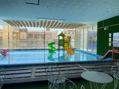 a swimming pool with a slide and a playground at Cookies Homestay Vung Tau Gold Sea (Căn Hộ Biển) in Vung Tau