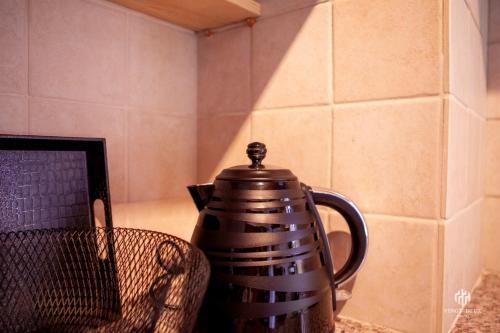 a tea kettle sitting on a table next to a laptop at VINGT-DEUX Vouni 22 in Vouni