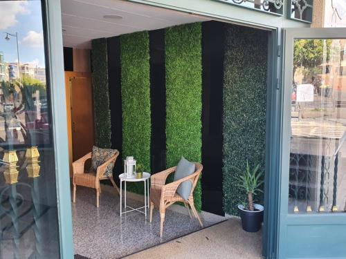 a table and chairs on the side of a building at Hostal Fronton in Alcobendas