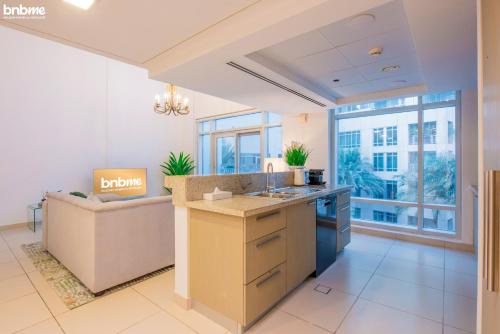 a kitchen with a sink and a couch at bnbmehomes - Duplex Living walk to Burj K and Dubai Mall - L313 in Dubai