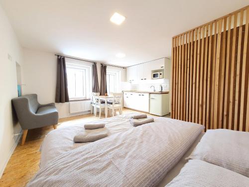 a bedroom with a large bed with two pillows on it at Apartmány U Muzea in Horní Blatná