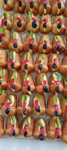 a tray full of pastries with fruit on them at Hotel Ascot Riccione in Riccione