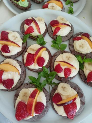 a plate of cookies with strawberries and cream at Hotel Ascot Riccione in Riccione
