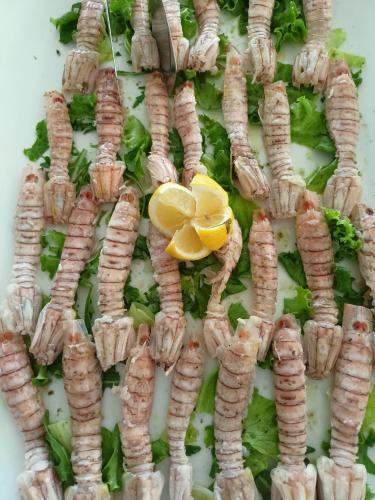a pile of parsley and lemons on a plate at Hotel Ascot Riccione in Riccione