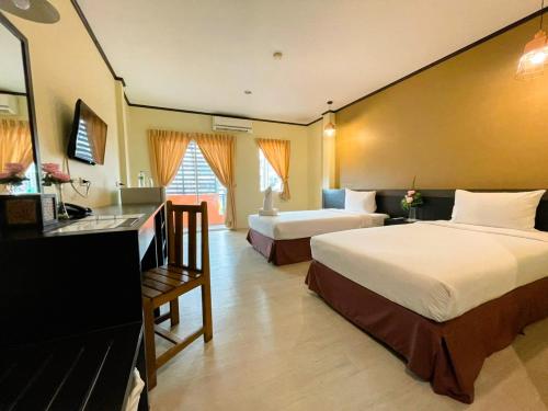 a hotel room with two beds and a sink at S.B.Living Place in Phuket Town