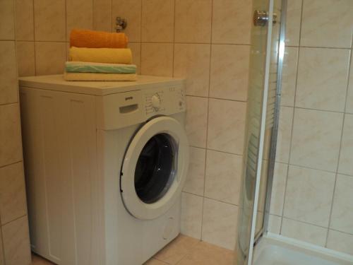 a washing machine in a bathroom with a shower at Apartment in Slatine with terrace, air conditioning, WiFi, washing machine (4782-3) in Slatine