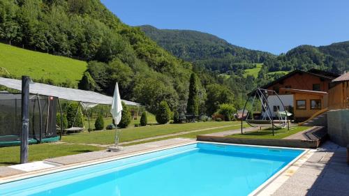 a swimming pool with a view of a mountain at Ferienwohnungen Koflerhof in Castelrotto