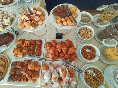 a table with many different types of food on it at Hotel Ascot Riccione in Riccione