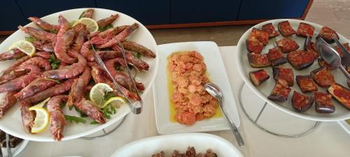 a table with three plates of food on it at Hotel Ascot Riccione in Riccione