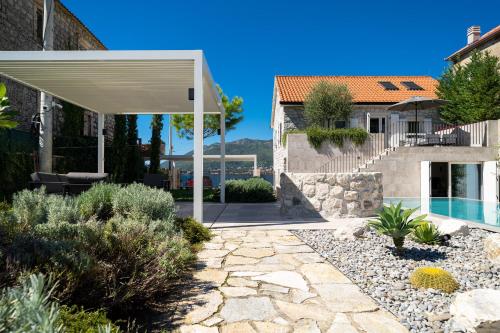 a backyard with a pool and a house with a pavilion at Villa Lastva in Tivat