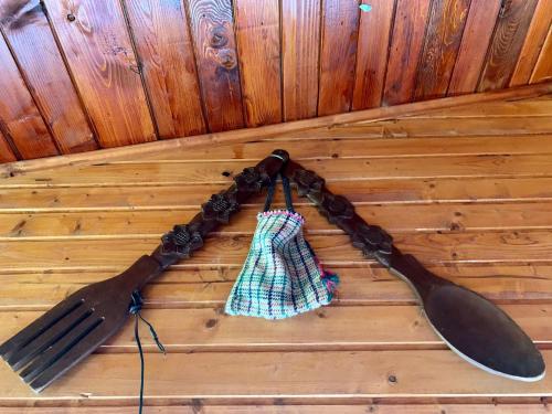 a knife and a spoon hanging on a wall at Cabana Cheile Valisoarei in Vălişoara