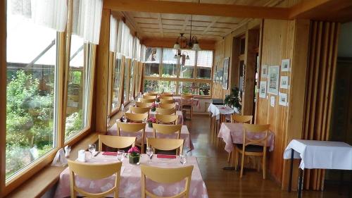 a row of tables and chairs in a restaurant at Ferienhof Krinde in Ringoldswil