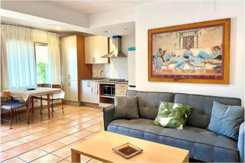 a living room with a couch and a table at Apartamentos Villamor in Denia