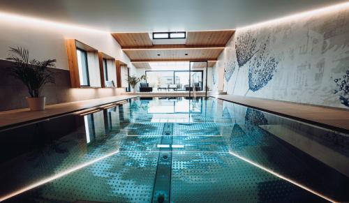 a swimming pool in a building with a pool at Hotel-Gasthof Beim Böckhiasl in Neukirchen an der Vöckla