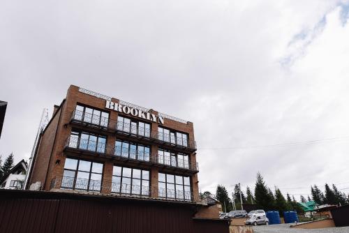 a brick building with a sign on top of it at Brooklyn in Yablunytsya