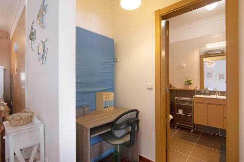 a small bathroom with a desk and a sink at Santa Luzia Apartment Sl016 in Santa Luzia