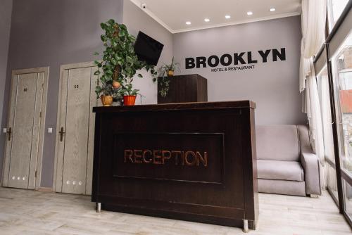 a reception desk in a room with a sign on the wall at Brooklyn in Yablunytsya