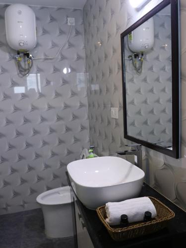 a bathroom with a white sink and a mirror at Cloud Walk in Kodaikānāl