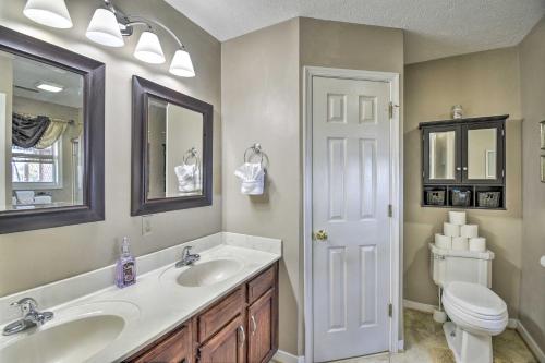 a bathroom with a sink and a toilet and a mirror at Gloucester Retreat with Backyard Oasis and Pier! in Gloucester