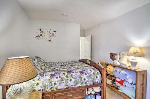 a bedroom with a bed and a lamp and stuffed animals at Gloucester Retreat with Backyard Oasis and Pier! in Gloucester