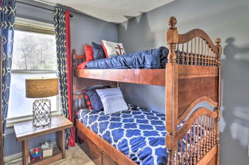 a bedroom with two bunk beds with blue walls at Gloucester Retreat with Backyard Oasis and Pier! in Gloucester