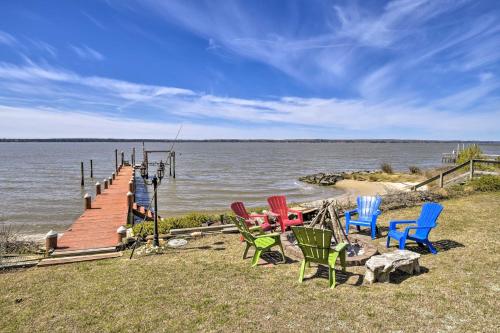 a group of chairs sitting on a dock next to the water at Gloucester Retreat with Backyard Oasis and Pier! in Gloucester