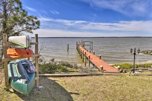 a dock on a body of water with a boat at Gloucester Retreat with Backyard Oasis and Pier! in Gloucester