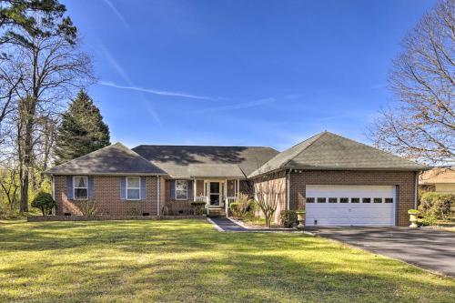 a large brick house with a garage at Gloucester Retreat with Backyard Oasis and Pier! in Gloucester