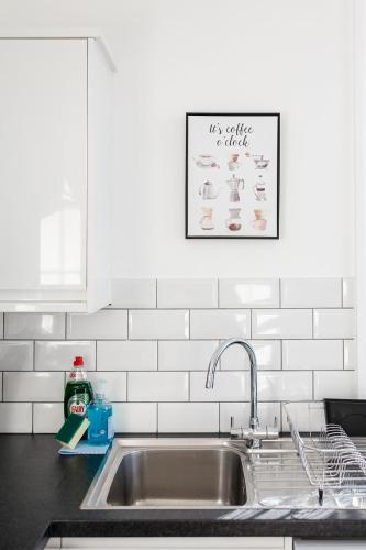 a kitchen sink with a sign on the wall above it at A View Of The Bay- Close to Margate - Sleeps 3 in Westgate-on-Sea