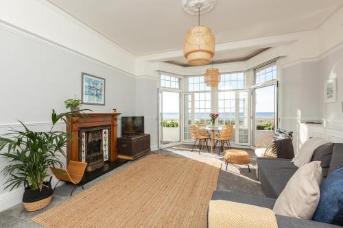 a living room with a couch and a fireplace at SoHot Stays - Sea Views From Every Room in Westgate on Sea