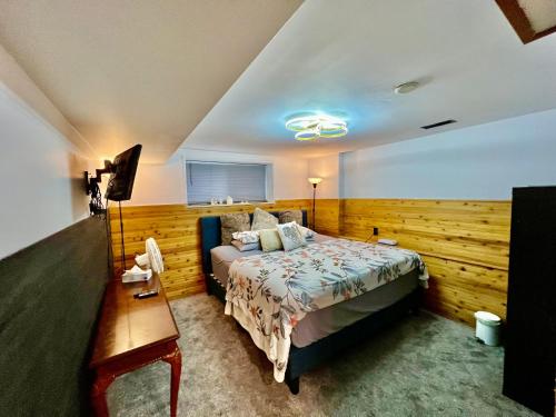 a bedroom with a bed and a wooden wall at Resort style home living in Delta