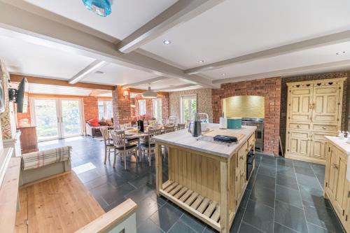 a kitchen with an island in the middle of a room at Sandbeds Farmhouse in Kendal