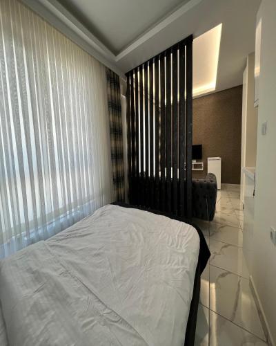 a bedroom with a bed and a large window at Tower352 in Melikgazi