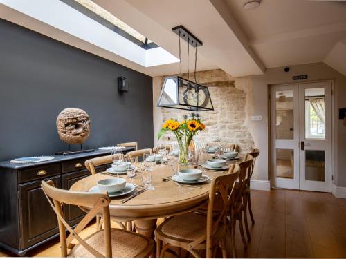 a dining room with a wooden table and chairs at Stow House in Stow on the Wold