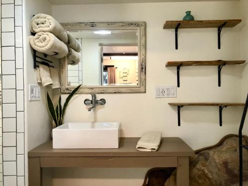 a bathroom with a sink and a mirror at Prickly Pear Unique Studio with bathroom built into the Granite boulders, Amazing Views, Front & back porches, Firepit,Dog friendly in Prescott