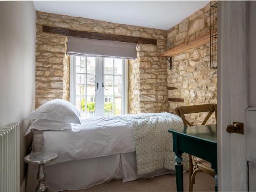 a bedroom with a bed and a window at Stow House in Stow on the Wold