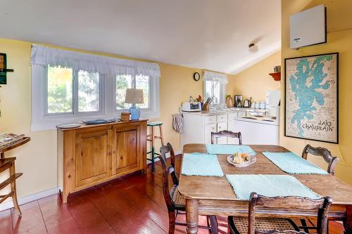 a dining room with a table and a kitchen at Charming St Albans Cottage on Lake Champlain! in Melville Landing